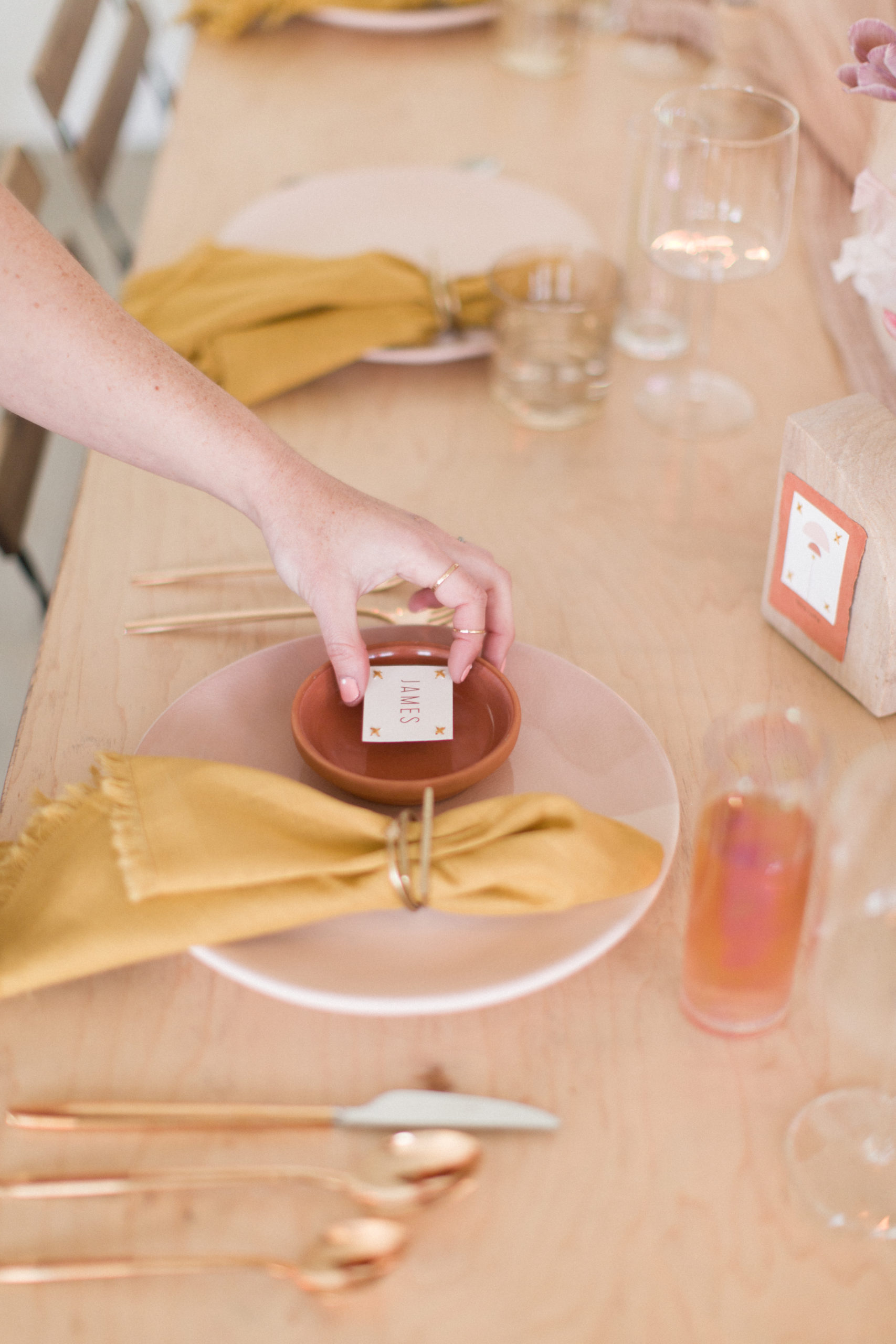 a wedding planner places a place card down at the table