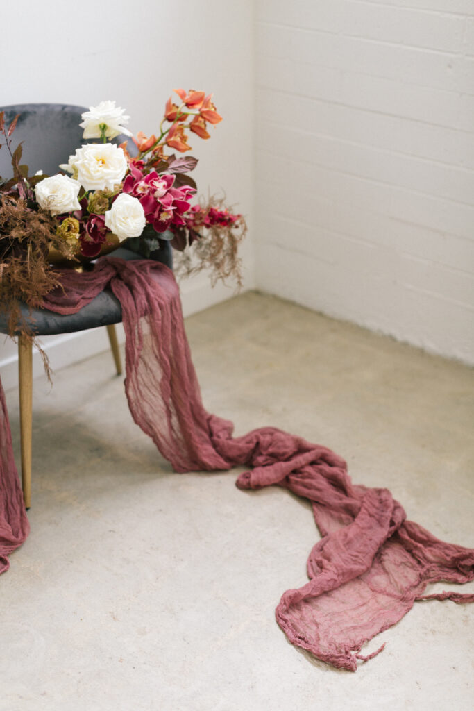 A chair adorned with a bouquet of flowers for building a wedding brand.